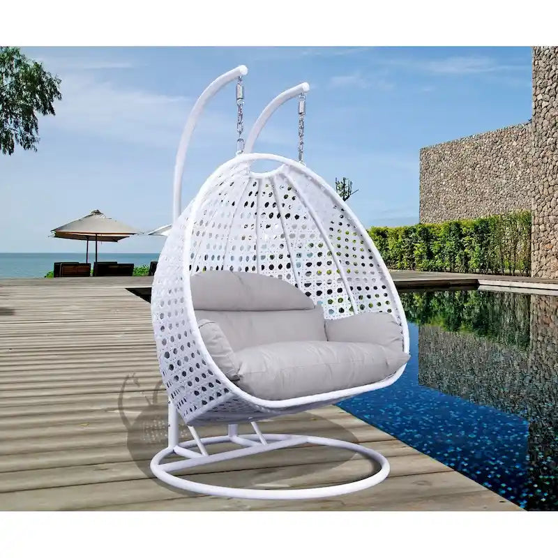 LeisureMod Hängesessel in Ei-Form für 2 Personen mit Gestell - Rattan-Pendelsessel für drinnen und draußen, Hängemattensessel für die Terrasse mit Kissen