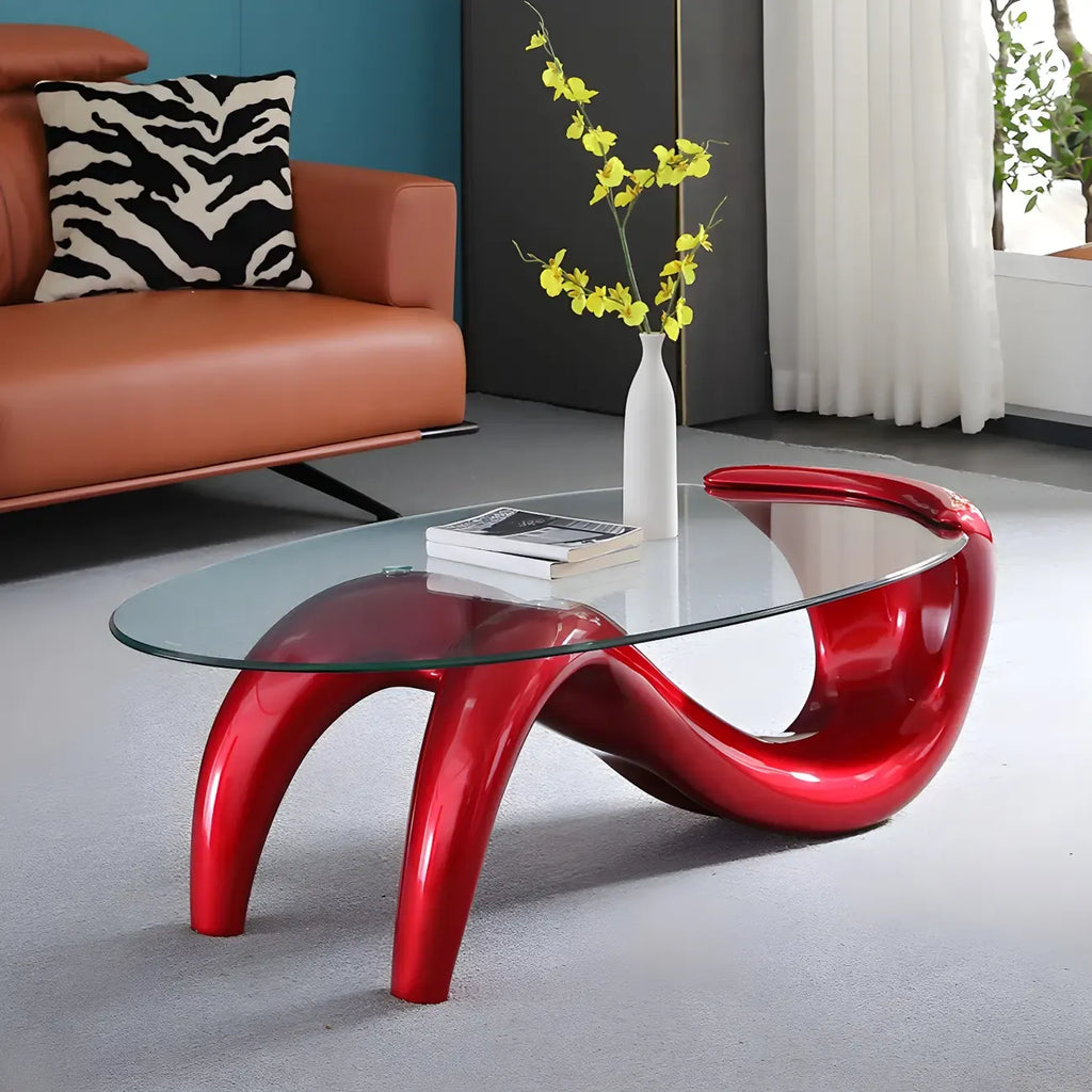 Abstracte moderne salontafel met ovaal glazen blad en metalen onderstel